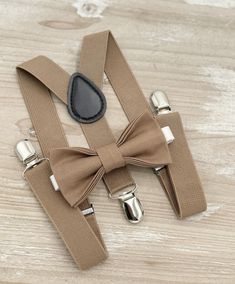 Your special guy will look so handsome when he shows up in his Taupe bow tie, pocket square and suspenders! Great set for groomsman, best man or ring bearers - This bow tie & suspenders set is a great choice for family photos, wedding, ring bearer outfit, birthday celebration or any other special occasion. When making a purchase, you can choose from the following options : -Suspenders Only -Bow Tie Only. -Suspenders + Bow Tie Set. - Pocket Square only. -3 Pieces Set : bow tie + suspenders + pock Bow Tie And Suspenders Set For Father's Day Party, Adjustable Dapper Belts And Suspenders For Party, Adjustable Bow Tie For Groom, Adjustable Bow Tie With Suspenders For Black Tie Events, Wedding Ring Bearer Outfit, Family Photos Wedding, Wedding Ring Bearer, Bowtie And Suspenders, Bearer Outfit