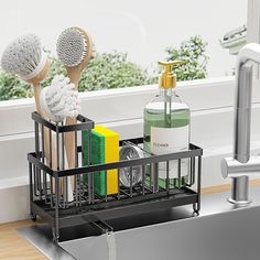 a kitchen sink with soap, toothbrushes and other cleaning products in it next to a faucet