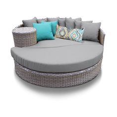 an outdoor day bed with pillows and throw pillows on the top, in front of a white background