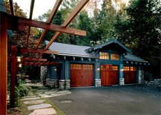 a house with two garages and a pergolated roof