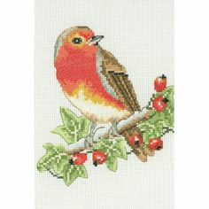 a cross stitch bird sitting on top of a tree branch