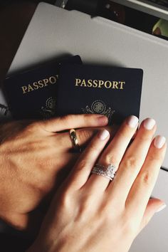 two people are holding their hands together to each other while wearing rings on their fingers