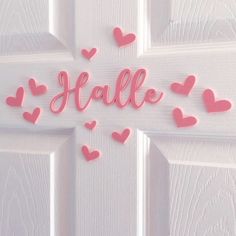 a door with pink hearts on it and the word hale spelled in cursive letters