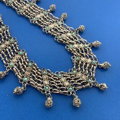 * Vintage Silver Tone Floral Lattice Turquoise 7 Strand Statement Collar Necklace * Length: 18-1/2" * Width: 1-1/2" * Turquoise total carat weight: approximately 1.5 tcw * Weight: 69.0 tgw * Unmarked * Professionally assayed * Clasp: Hook and Eye * Condition: As pictured. (ZAT225BR) * S4537    Exported By ExportYourStore :) Ornate Turquoise Filigree Jewelry, Traditional Turquoise Jewelry With Filigree, Traditional Turquoise Filigree Jewelry, Blue Bohemian Necklace With Intricate Design, Bohemian Blue Necklace With Intricate Design, Statement Collar, Statement Collar Necklace, Collar Necklace, Necklace Length