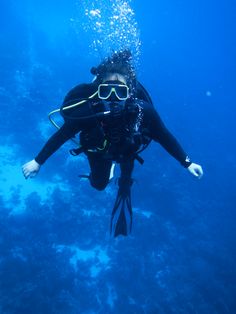 a person in scuba gear diving under the water