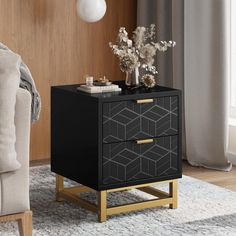 a black and gold side table with flowers on it in front of a couch, chair