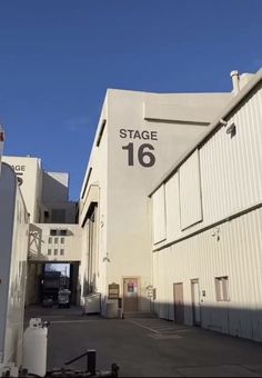 an empty parking lot in front of a large building with the number 16 on it