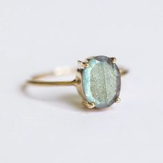 How can something so simple as an oval Labradorite solitaire ring, be so beautiful you ask? The answer is in the gemstone itself. With a gorgeous silvery-green color, this ring just pops out on your finger and dazzles everyone. To turn it up a notch, add complimentary stacking rings, to create a one-of-a-kind ring set - something extra special for yourself or your loved one. Details: Center Gemstone: Labradorite Stone Shape: Oval Measurements: approx. 9x7 mm Weight: approx 1.75 ct Band measureme Labradorite Rings, Planet Ring, Stacker Rings, Moss Agate Ring, Rose Quartz Ring, Demi Fine Jewelry, Labradorite Ring, Agate Ring, Swiss Blue Topaz