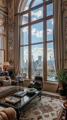 a living room filled with lots of furniture and large windows overlooking the cityscape