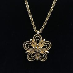 "This daisy pendant and gold chain necklace is gold plated. The rope style chain measures 16 inches and holds a 1.75 inch, open work five petal flower pendant. The back of the pendent is marked,\" MONET c\". It has a nice weight to it and not heavy. The spring clasp is original to the necklace. There is a small metal tag marked,stamped, \"Monet\" with a, \"C\" in a circle on the back. The multiple gold plating is still in excellent condition. This metal necklace is circa 1965 and made by a high end costume jewelry maker of the time, Monet.  The first half of the 20th century was the heyday for well made costume jewelry sold from fine department stores to Woolworth, usually made in Europe or the United States. The manufacture and quality of costume jewelry deteriorated in the latter part of Retro Brass Pendant Jewelry, Retro Gold Jewelry With Adjustable Chain, Retro Gold-tone Jewelry Gift, Retro Gold-tone Jewelry For Gift, Vintage Metal Necklace With Flower Pendant, Gold Retro Round Pendant Necklace, Gold Retro Round Pendant Jewelry, Retro Gold Necklace With Adjustable Chain, Gold Flower Pendant Costume Necklace