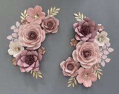 paper flowers arranged in the shape of letters s and v on a gray background with gold leaves