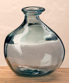 a glass vase sitting on top of a wooden table