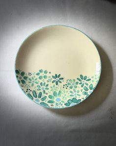 a blue and white plate with flowers on it