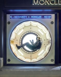 the reflection of a man in a clock on display at moncley, paris