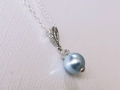 Wedding Swarovski 8mm Light Blue Pearl Drop Pendant with .925 Sterling Silver Chain Bridal Necklace. CHAIN is 18 inches (45.7cm) long. PENDANT is about 0.75 inch (2cm) long including bail. Elegant and timeless, this dainty necklace is perfect for weddings or special occasions such as birthdays, anniversaries, graduations, proms...or whatever you can imagine! Handmade necklace, is made with .925 Sterling Silver 18 inches cable chain, Swarovski 8mm Light Blue round crystal pearl, Rhodium Sterling Light Blue Jewelry For Wedding, Blue Round Pendant Jewelry For Wedding, Elegant Light Blue Necklace For Anniversary, Elegant Light Blue Jewelry For Wedding, Blue Round Pendant Necklace For Wedding, Sapphire Round Pendant Jewelry For Wedding, Formal Blue Jewelry With Pearl Pendant, Sapphire Round Pendant For Wedding, Blue Round Pendant Necklaces For Weddings