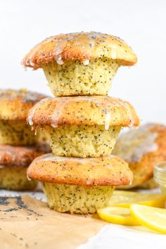 lemon poppy seed muffins stacked on top of each other with lemon wedges