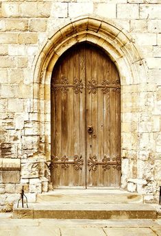 an old stone building with a wooden door