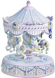 a white carousel with horses on it