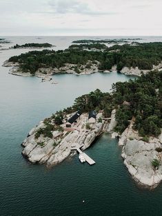 an island in the middle of water surrounded by trees