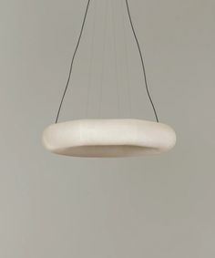 a white circular light hanging from a ceiling