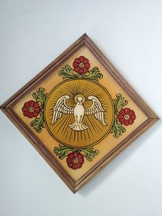 a painting on the wall with flowers and an angel in it's center frame