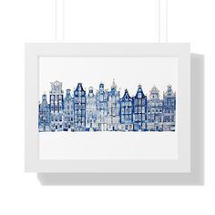 a blue and white cityscape is hanging on the wall in front of a white frame