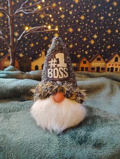 a close up of a gnome's hat on top of a blanket with lights in the background