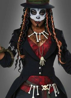 a woman in a skeleton costume with long braids and a top hat is posing for the camera