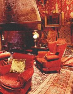 a living room filled with furniture and a fire place in the middle of it's walls