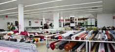 a room filled with lots of different colored fabrics