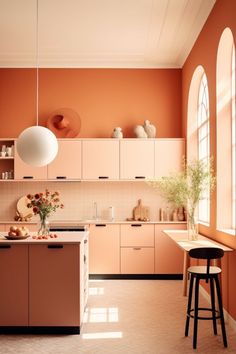 an orange and white kitchen with two stools