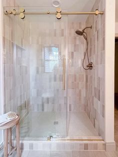 a walk in shower sitting inside of a bathroom