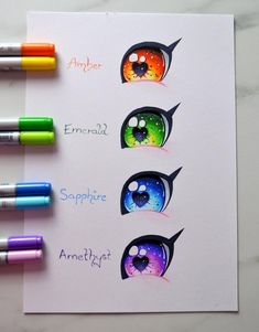 four different colored markers are on top of a piece of paper with an eyeball