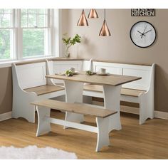 a kitchen table with benches and a clock on the wall