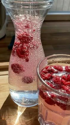 a pitcher and glass filled with liquid on top of a table