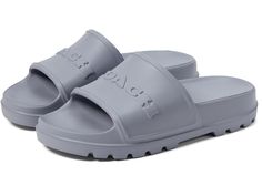 COACH Jesse Slide - Women's Shoes : Grey Blue : Please Note: COACH items cannot be shipped to military addresses (APO or FPO) and addresses in Hawaii, the Virgin Islands, Guam or any other locations outside of the continental US. Light, comfortable, and stylish, the COACH Jesse Slide is a must-have addition to your footwear collection. Crafted with a synthetic upper, these slide sandals are both trendy and long-lasting. The synthetic lining and insole ensure a comfortable feel all day long, no matter where your adventures take you. Slip-on style. Brand lettering on the upper. Open, round toe design. Synthetic outsole. Made In Brazil. Measurements: Weight: 8 oz Product measurements were taken using size 8, width B - Medium. Please note that measurements may vary by size. Coach Casual Slides With Cushioned Footbed, Casual Coach Slides With Cushioned Footbed, Casual Coach Slides With Branded Insole, Coach Casual Slides With Round Toe, Casual Coach Slides With Round Toe, Brand Lettering, The Virgin Islands, Artist Branding, Shoes Grey