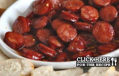 a white bowl filled with hot dogs next to slices of bread