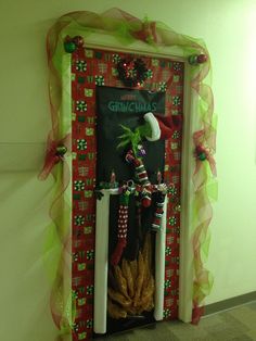 an open door decorated with christmas decorations and candy canes in front of a green wall