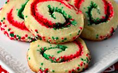 christmas sugar cookies with sprinkles on a white plate