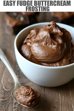 a bowl filled with chocolate frosting next to a spoon