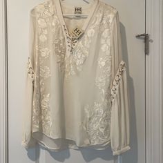 Never Worn Haute Hippie Embroidered Lace Up, Lace Up Detail On The Sleeve. Size Medium. Cream Color. White V-neck Blouse With Intricate Embroidery, V-neck Lace Blouse With Floral Embroidery, Embroidered Lace V-neck Top, Lace V-neck Blouse With Floral Embroidery, Summer Floral Embroidered Long Sleeve Lace Top, Summer Long Sleeve Lace Top With Floral Embroidery, White Lace Top With Floral Embroidery And Long Sleeves, Embroidered Long Sleeve Cream Blouse, Spring White Blouse With Tonal Embroidery