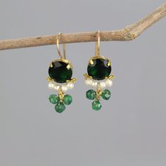 A pair of glowing and dainty clover earrings set with green zircon in copper bezel. Beautiful pearls encircle the lower part of the green zircon, and three striking aventurine gemstones are interwoven gently. This unique earrings design is timeless, so you can enjoy it for years and years to come.  The hook is made of gold filled.  Materials:  Stone: green zircon, pearls, aventurine Metal: gold filled, copper bezel Measurements:  Length including hook: 3cm Width: 15mm Green zircon in diameter: 10mm Since I mostly use natural gemstones, each jewel is unique and therefore there are subtle differences in color and form. Pearl properties: Offers the power of love, money, protection, and luck.  Find more clover earrings here: https://etsy.me/2BSBuLs Click here for more earrings: https://etsy.me Dainty Earrings For Jewelry Making With May Birthstone, Green Dangle Pearl Earrings For Pierced Ears, Green Dainty Dangle Earrings, Dainty Green Dangle Earrings, Green Pearl Drop Earrings For May Birthstone, Single Green Pearl Drop Earrings, Green Gemstone Drop Pearl Earrings, Green Round Pearl Drop Earrings, Green Gemstone Pearl Drop Earrings