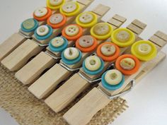 several wooden pegs with different colored buttons on them