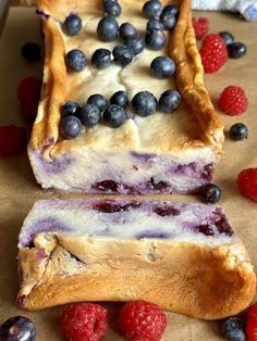 some blueberries and raspberry pies sitting on top of a piece of parchment paper