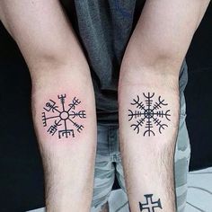 two people with matching tattoos on their arms