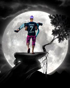 a man standing on top of a cliff under a full moon