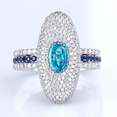 For Sale on 1stdibs - Ring with 0.55-carat crystal-clear cabochon of extremely rare neon-blue natural Brazilian Paraiba sitting in the micro pave-studded diamond cloud. The Luxury Gia Certified Diamond White Sapphire Ring, Luxury Oval Sapphire Ring With Pave Setting, Dazzling Sapphire Ring With Pave Setting, Luxury Sapphire Diamond Ring With Vvs Clarity, Luxury Diamond White Baguette Cut Sapphire Ring, Dazzling Sapphire Ring With Pave Diamond Setting, Oval Sapphire Ring With Pave Setting In Platinum, Luxury Round Diamond Topaz Ring, Luxury Round Topaz Ring With Diamonds