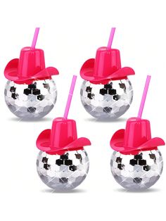 four shiny disco balls with hats on top and pink straws in the middle, set of 4