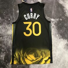 the jersey worn by stephen curry is displayed on a gray background with white and yellow flowers