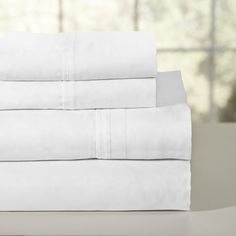 four white sheets stacked on top of each other